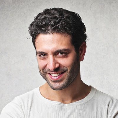 A man with curly hair and a white shirt