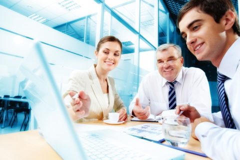 A group of people sitting around a table.