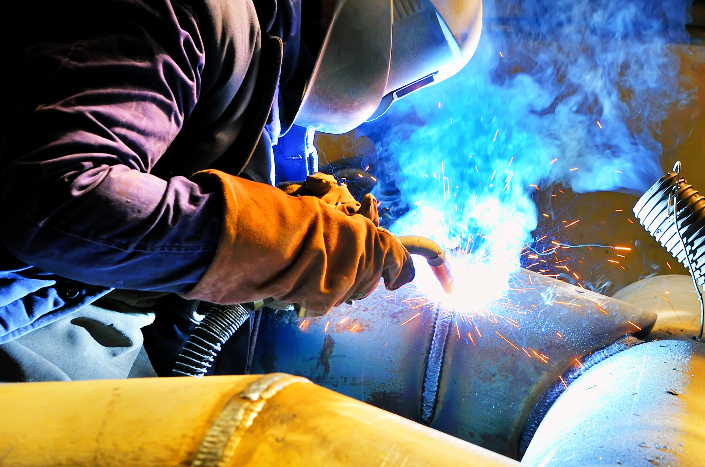 A man welding in the process of being welded.