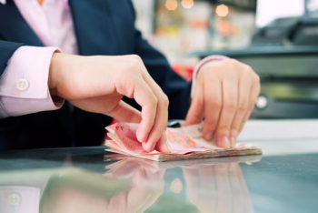 A person is cutting paper with scissors.