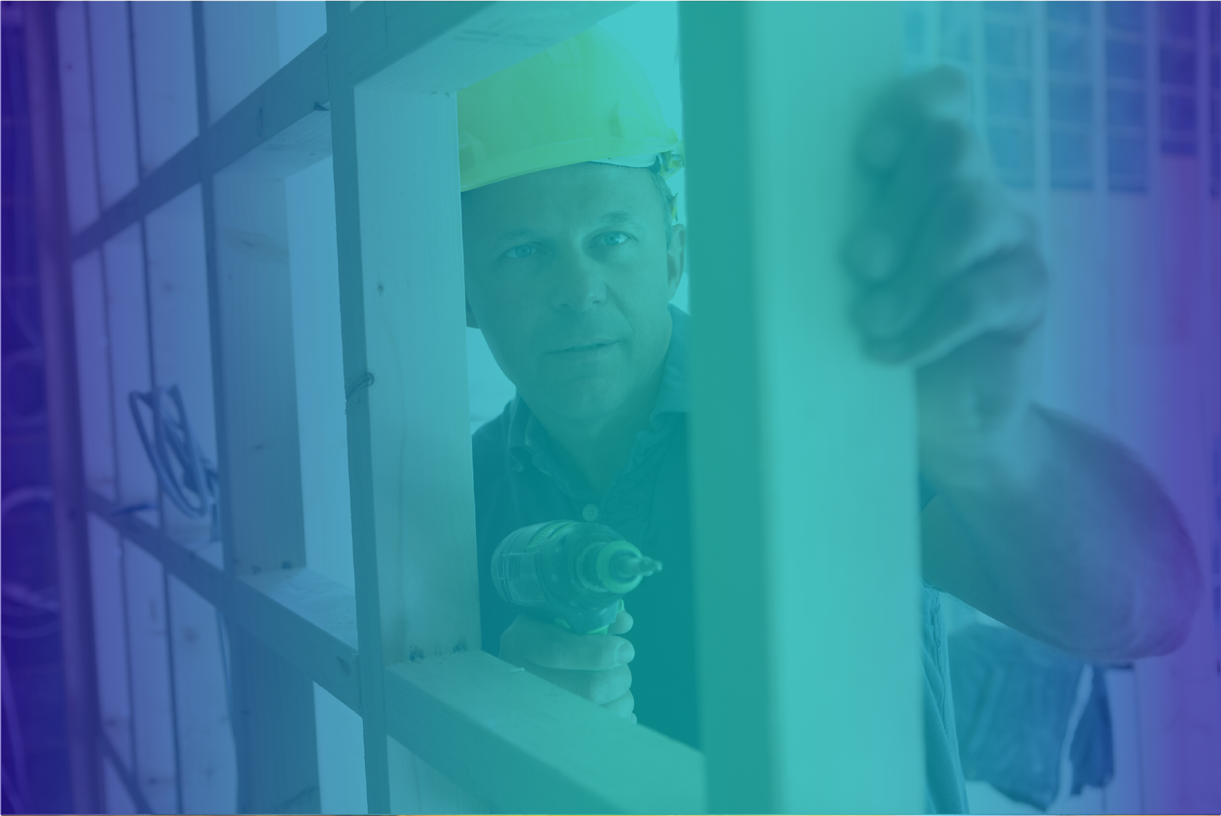 A man in a hard hat looking through the window.